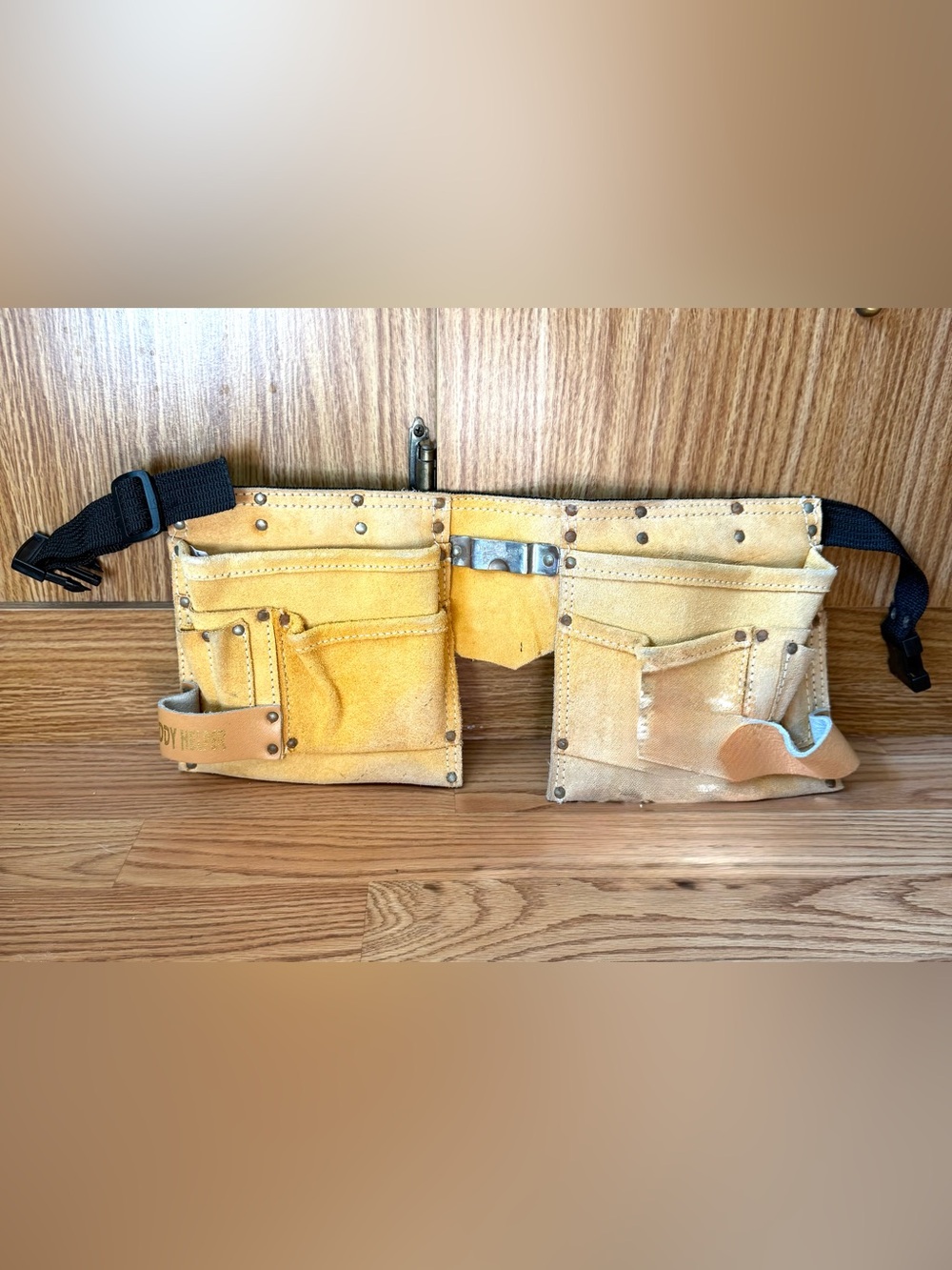 Suede leather Tool-belt that says
”Daddy Helper”n large gold letters in front.